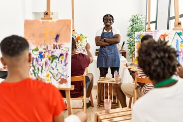 Group of young african american artist students drawing in paint class at art studio.