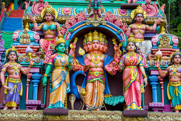 The God sculpture main entrance of Batu Caves in Gombak, Selangor, Malaysia,  which is one of the most popular Hindu shrines outside India.
The background is 272 colorful steps. - obrazy, fototapety, plakaty