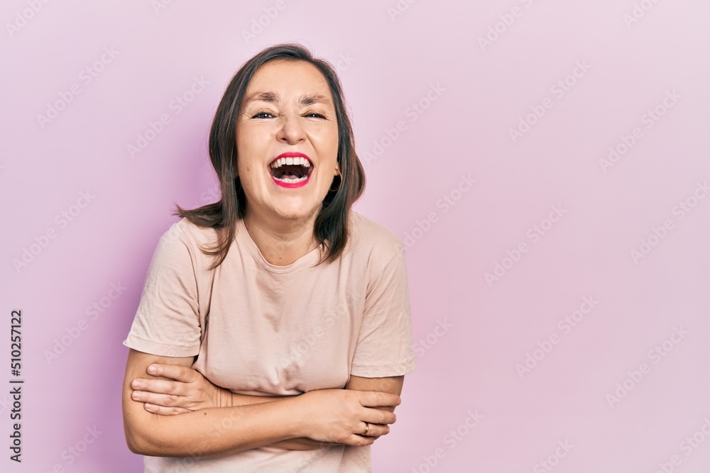 Sticker middle age hispanic woman with arms crossed gesture smiling and laughing hard out loud because funny