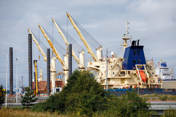 Landscape of Klaipeda port with ships, containers, ferries and cranes.