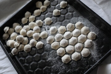 raw frozen dumplings on a black dish