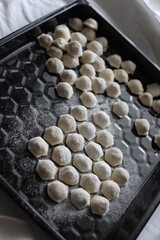 raw frozen dumplings on a black dish