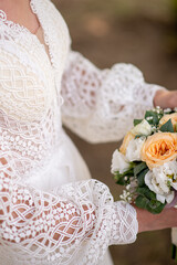 the bride in a white dress holds a bouquet of bloom flowers in her hands. idea for wedding event agencies