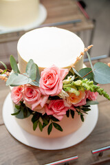 wedding cake decorated with rose flowers at the banquet. concept for a wedding event agency