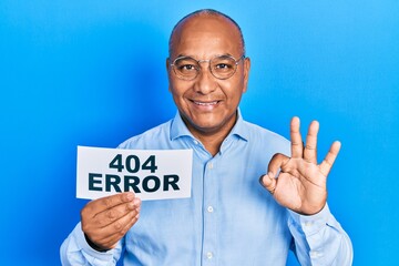 Fototapeta na wymiar Middle age latin man holding paper with 404 error message doing ok sign with fingers, smiling friendly gesturing excellent symbol