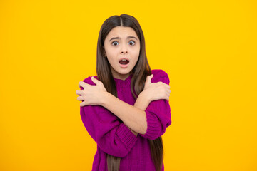 Surprised emotions of young teenager girl. Teenager child girl with shocked facial expression. Surprised face expression, isolated on yellow background. Funny surprise.