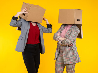 Women gossip. Girls with boxes. Women are talking and gesticulating with their hands. Girls hide...