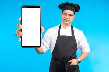 Chef man with phone. Culinary mobile offer. Cellphone with white screen. Mock up phone in hand chef...