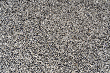 Crushed stone. Small gray stones. Abstract texture. Building material.