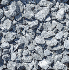 Gray stone for construction. Big rubble. Construction site. Crushed stone. Sale of stones.