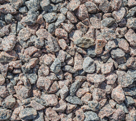 Decorative stones. Many small stones of rough structure, gray black brown color. Natural stone covering, drainage.