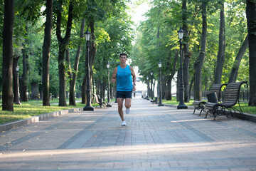 athletic man runner with fit body running in sportswear outdoor