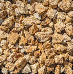 Decorative stones. Yellow small stones. Abstract background of colored stones.