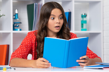 Back to school. Teenager school girl reading book ready to learn. Surprised face, surprise emotions of teenager girl.