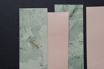grungy green and pink paper on gray
