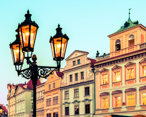 Fototapeta na wymiar Close-up glowing city lantern on Prague Old Town Square, Czech Republic. Architecture and landmark of Prague.