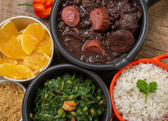 FEIJOADA: typical and traditional food of Brazilian cuisine, served with rice, farofa, orange, pepper and cabbage