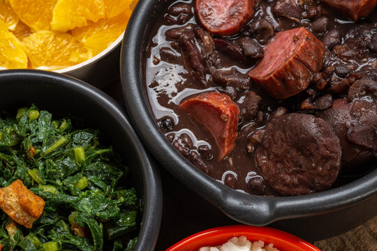 FEIJOADA: typical and traditional food of Brazilian cuisine, served with rice, farofa, orange, pepper and cabbage