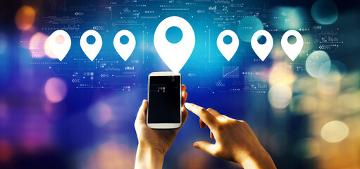 Map pin concept with person using a smartphone