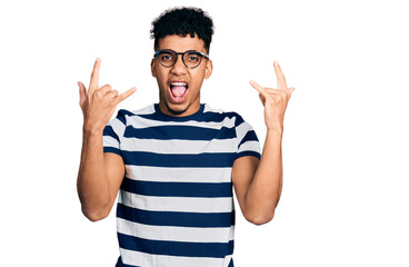 Young african american man wearing casual clothes and glasses shouting with crazy expression doing...
