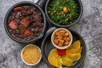 FEIJOADA: typical and traditional food of Brazilian cuisine, served with rice, farofa, orange, pepper and cabbage