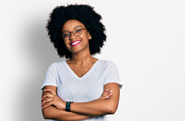 Fototapeta na wymiar Young african american woman wearing casual white t shirt happy face smiling with crossed arms looking at the camera. positive person.