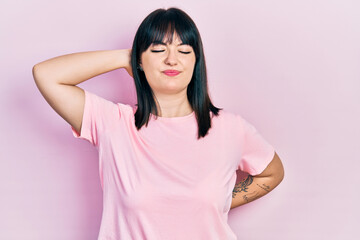 Fototapeta premium Young hispanic woman wearing casual clothes suffering of neck ache injury, touching neck with hand, muscular pain