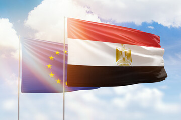 Sunny blue sky and flags of egypt and european union
