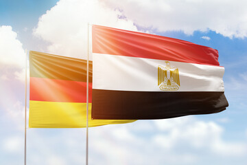 Sunny blue sky and flags of egypt and germany