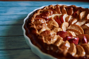 apple pie fresh pastries with apples red apples on a blue background white dishes