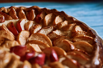 apple pie fresh pastries with apples red apples on a blue background white dishes