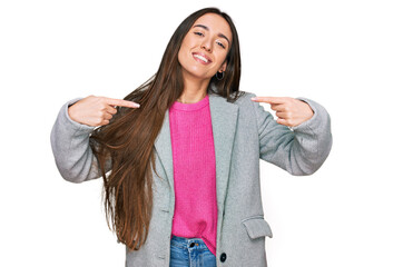 Young hispanic girl wearing business clothes looking confident with smile on face, pointing oneself...