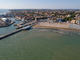 Fototapeta premium Italy, June 2022; aerial view of Fano with its sea, beaches, port, umbrellas in the marche region