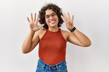 Young hispanic woman wearing glasses standing over isolated background showing and pointing up with...