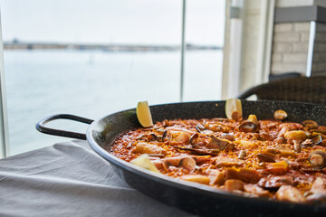  Delicious spanish shellfish paella on cloth surface