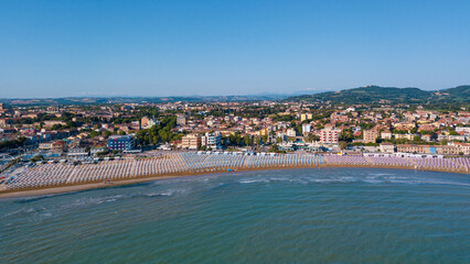 Fototapeta na wymiar Italy, June 2022; aerial view of Fano with its sea, beaches, port, umbrellas