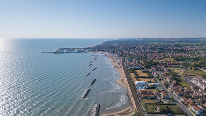Fototapeta premium Italy, June 2022; aerial view of Fano with its sea, beaches, port, umbrellas