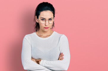 Obraz premium Young hispanic woman wearing casual clothes skeptic and nervous, disapproving expression on face with crossed arms. negative person.