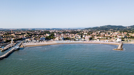 Naklejka na ściany i meble Italy, June 2022; aerial view of Fano with its sea, beaches, port, umbrellas