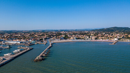 Fototapeta na wymiar Italy, June 2022; aerial view of Fano with its sea, beaches, port, umbrellas