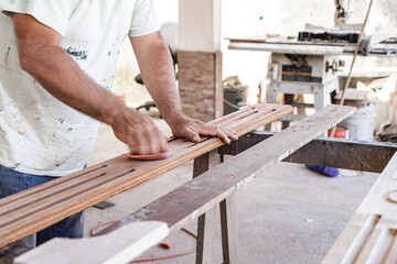 Image of an unknown man, doing carpentry work in his wood workshop.