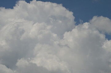 Large puffy white clouds on clear blue sky