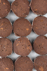 Chocolate palet breton cookies, chocolate sable cookies, french chocolate butter cookies, raw palet breton cookies sliced and placed on a parchment lined baking sheet 