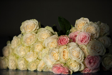 Beautiful vintage bouquet of white roses on a dark background.