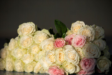 Beautiful vintage bouquet of white roses on a dark background.