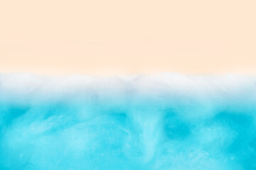 Soft gentle background from white cotton wool and blue paper.Conceptual sea from above.