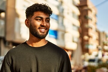 Young arab man smiling confident at street