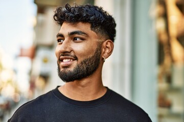 Young arab man smiling confident at street