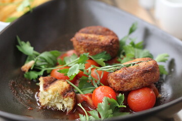 fish cutlets with cherry tomatoes and herbs
