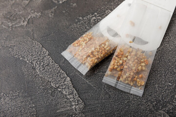 Buckwheat Tea Superfood. Close-up tea bag in a white tea cup on a black textured background. copy space.Place for text.